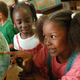 First-grader Khatona Miller, right, with classmates on August 22, 2000 at Chicago’s Stewart Elementary School. Image via Getty.